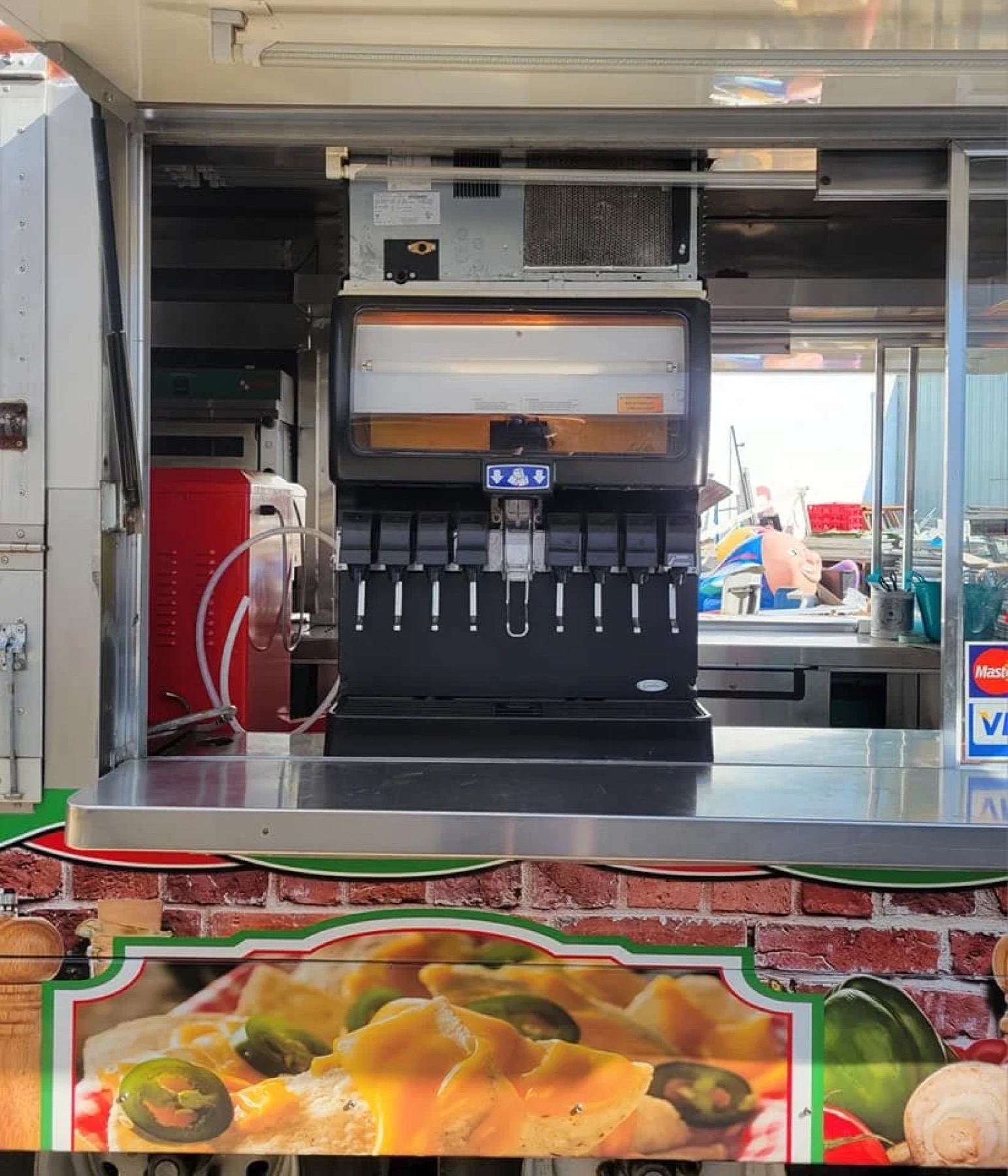 Soda fountain installed in a pizza and pretzel food truck service window