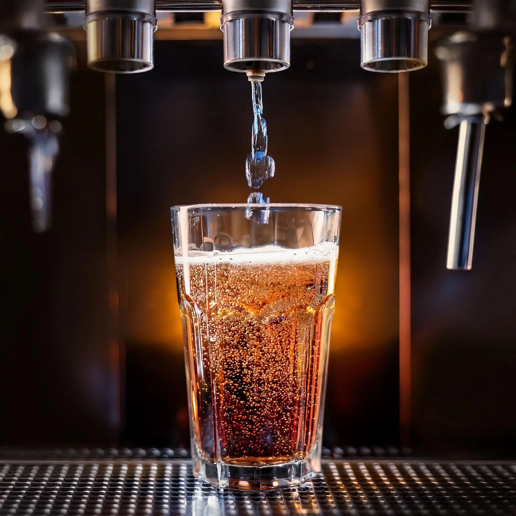 Commercial soda fountain pouring a carbonated beverage into a glass